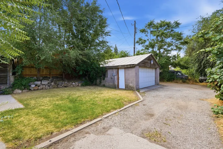 Detached garage featuring a metal roof and a single overhead door