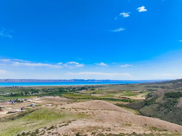 Expansive land parcel featuring varied topography, including rolling hills and flat areas