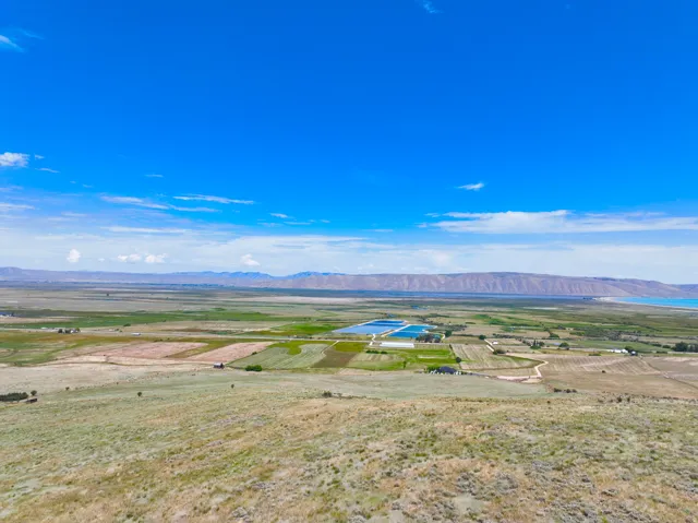 Expansive rural landscape featuring a mix of cultivated fields and natural terrain