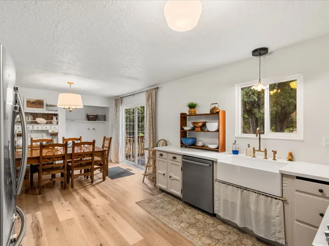 Kitchen and dining area featuring wood-finish flooring