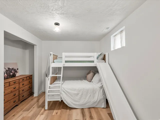 Light wood-finish flooring complements the neutral wall color
