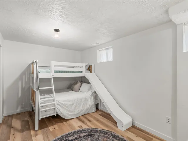 Room with wood-finish flooring and white walls