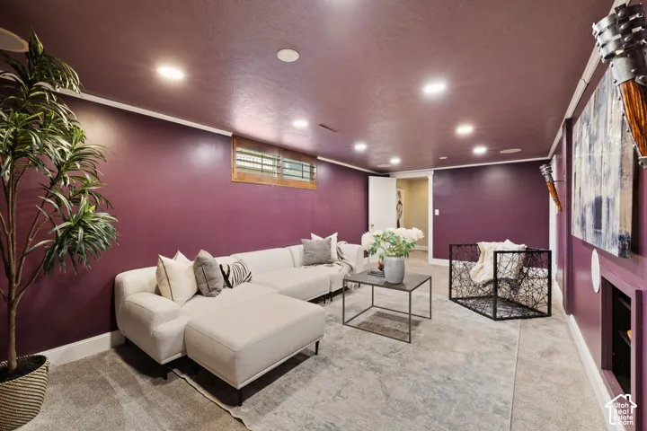 Spacious living area featuring recessed lighting, a window with wood trim, and wall-to-wall carpeting