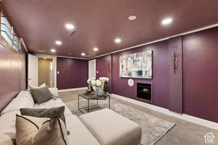 Recessed lighting illuminates this room, featuring rich-toned walls and matching ceiling