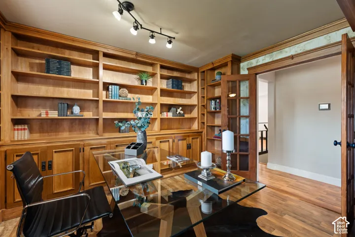 Built-in wood shelving and cabinetry with glass-paneled French doors