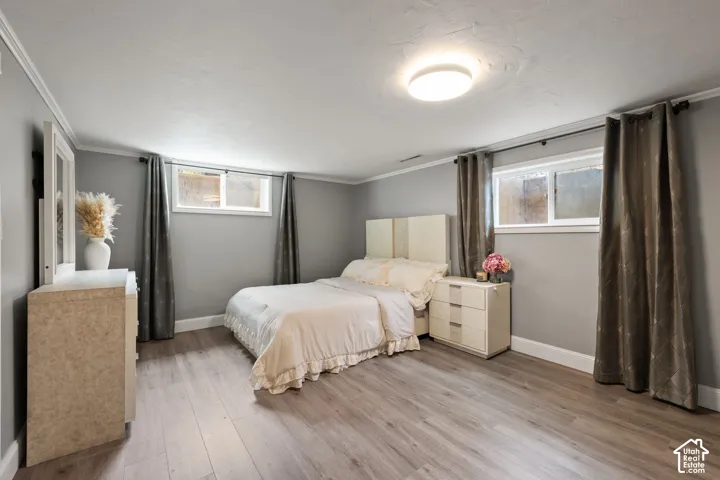 Well-appointed room featuring wood-finish flooring, light gray walls, and white trim
