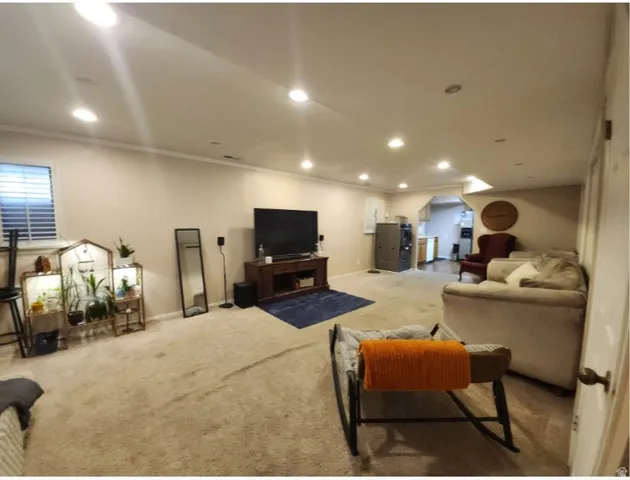 Spacious carpeted room featuring recessed lighting and crown molding