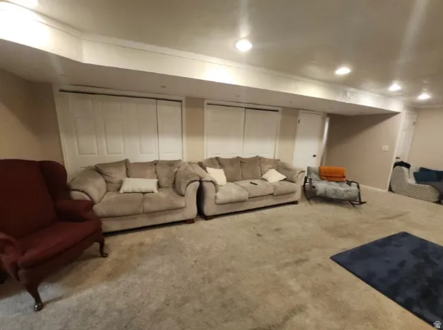 Lower level living area featuring wall-to-wall carpeting and recessed ceiling lighting