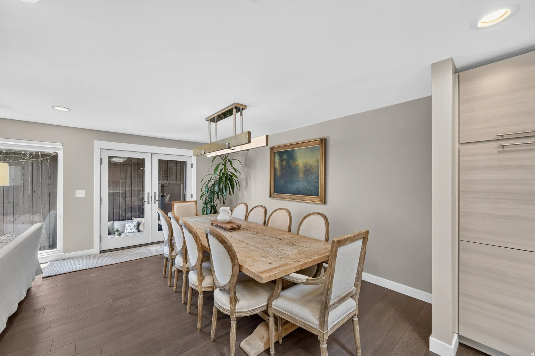 Dining area featuring double doors leading to covered patio and garage