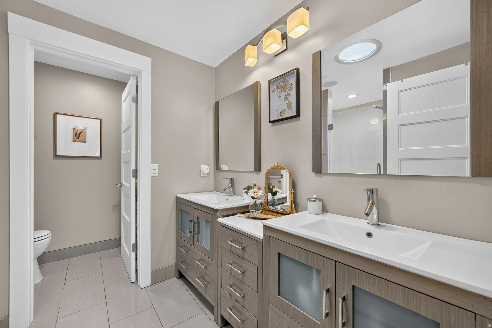 Double vanity with integrated sinks and wood-finish cabinetry