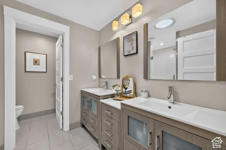 Double vanity with integrated sinks and wood-finish cabinetry
