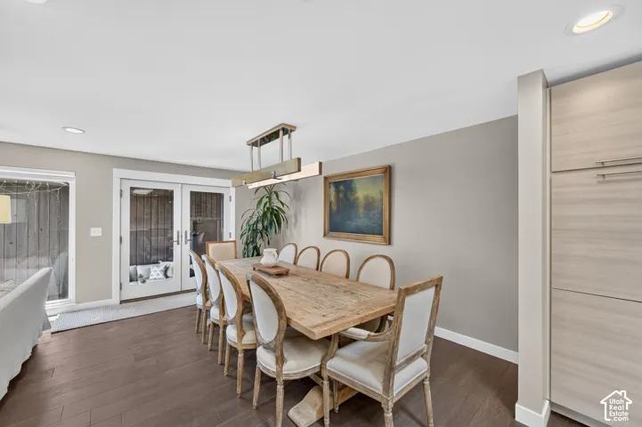 Dining area featuring double doors leading to covered patio and garage