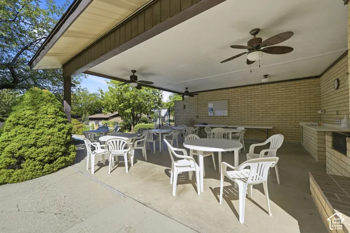 Covered patio featuring bathrooms and changing rooms, built-in outdoor sink, and ceiling fans