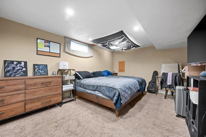 Carpeted room with recessed lighting and a single window opening