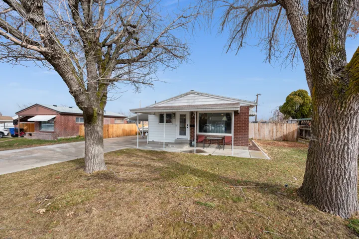 Brick and siding exterior featuring a covered front porch and expansive front window