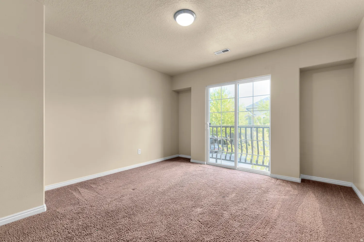 Room featuring a sliding glass door opening to an outdoor balcony