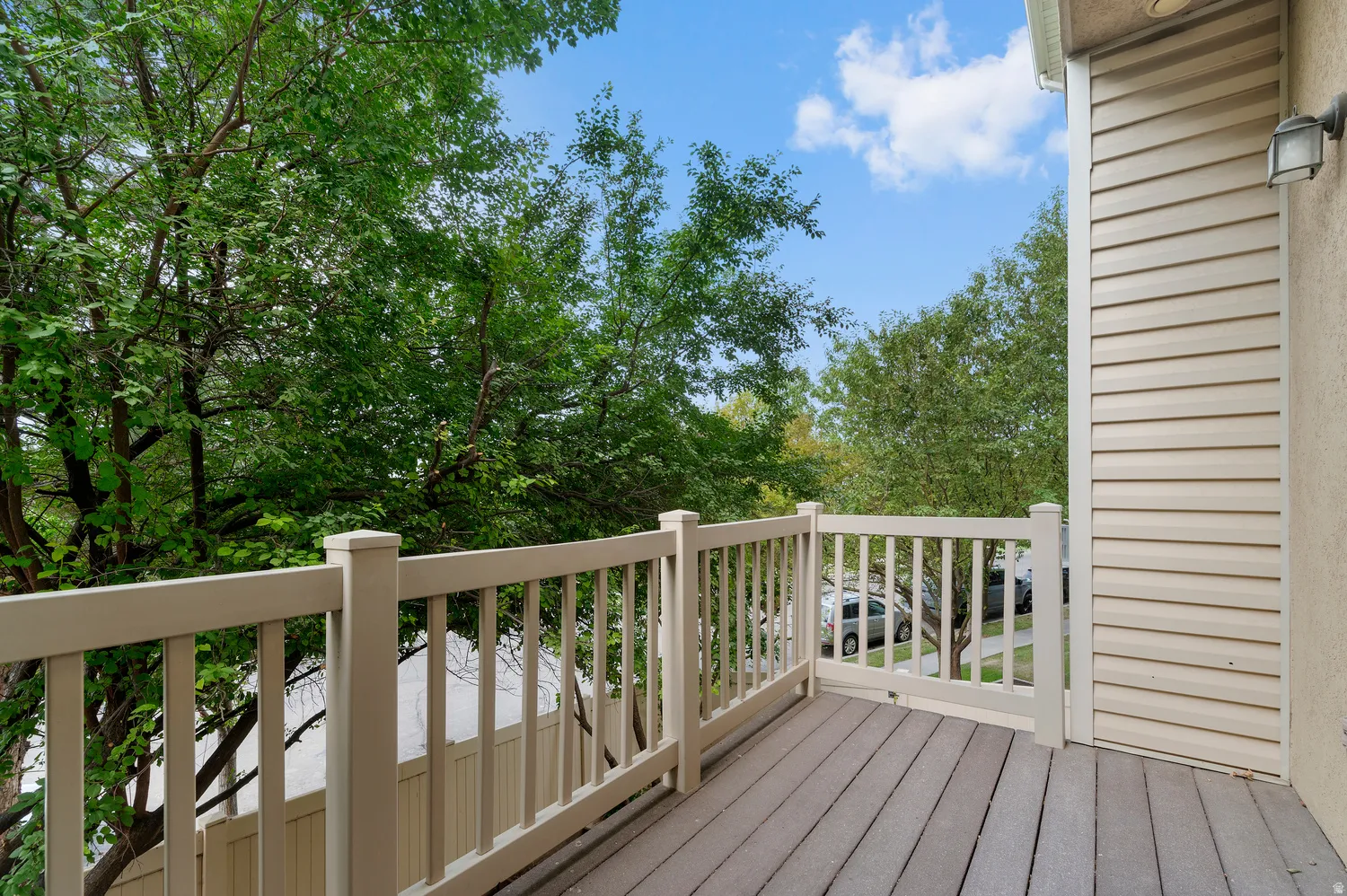 Outdoor deck featuring composite decking and light-toned railings