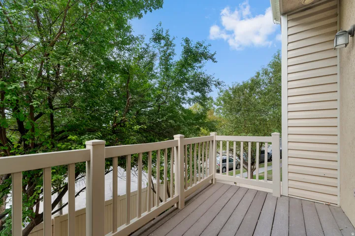 Outdoor deck featuring composite decking and light-toned railings