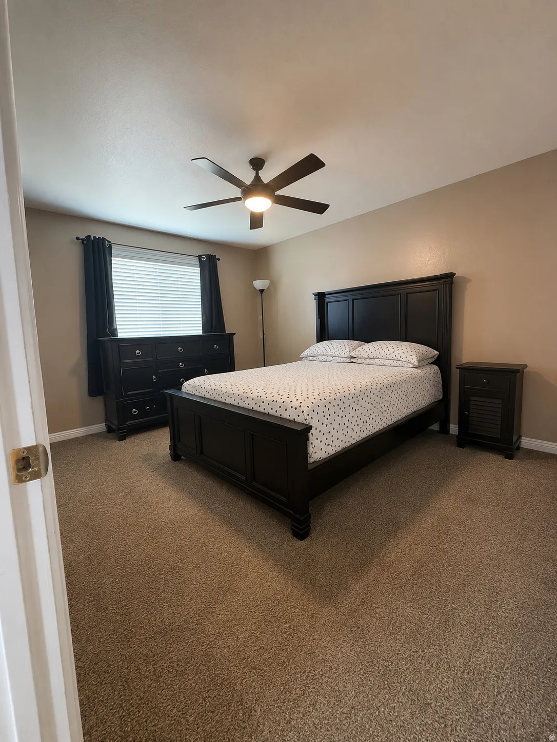 Neutral-toned walls complement plush carpeting