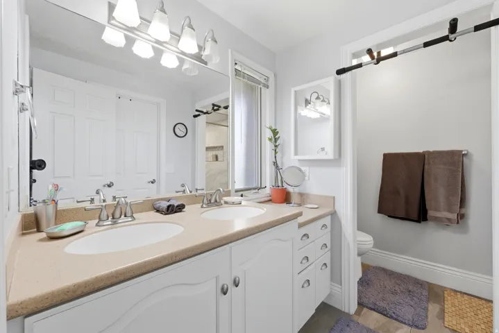Spacious bathroom with a dual vanity featuring two undermount sinks and a light-toned countertop