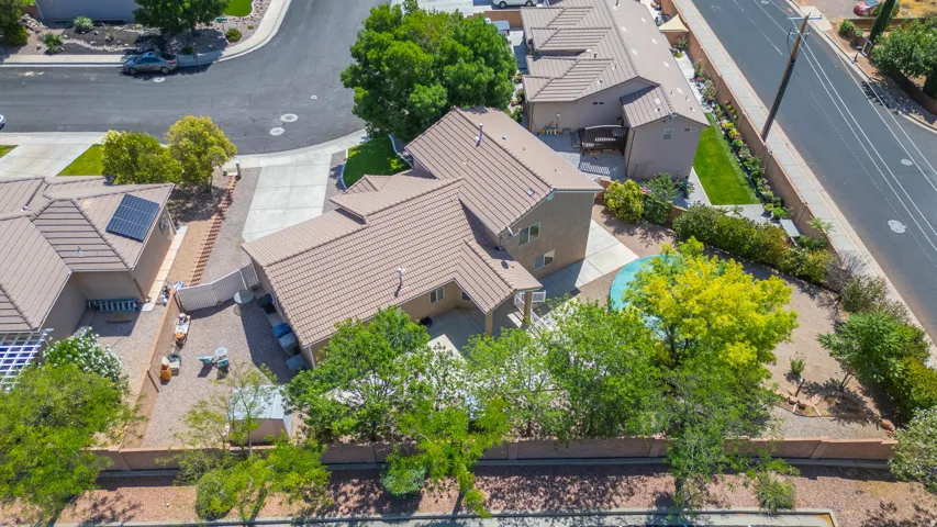 Aerial perspective showcasing a property with a tiled roof and a private pool