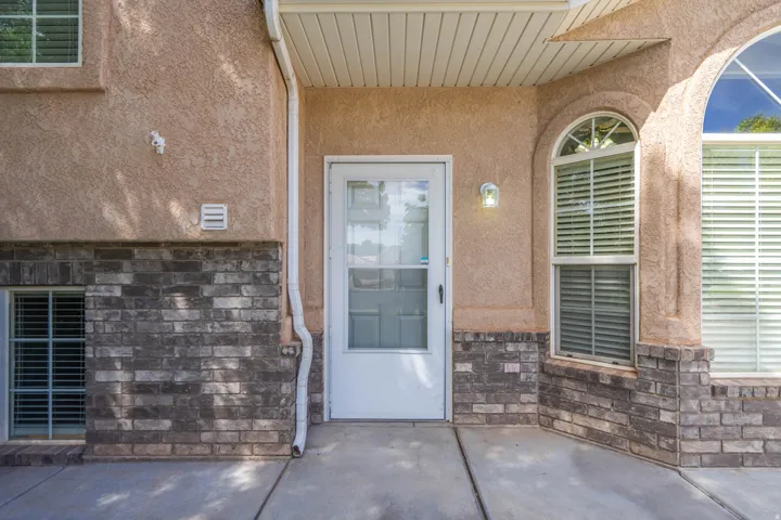Stucco exterior with a brick veneer foundation