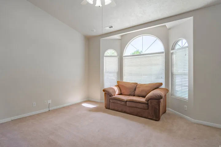 Bay window featuring multiple arched windows with blinds, recessed lighting, and a ceiling fan
