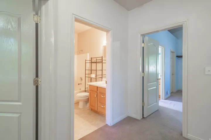 Hallway featuring neutral carpet flooring and white painted walls