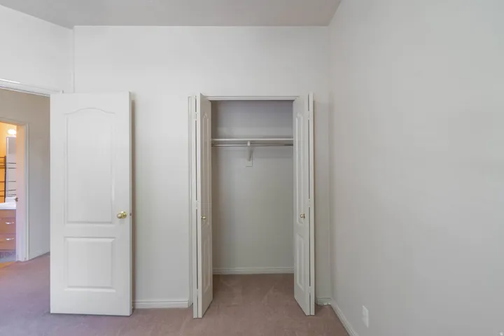 Recessed closet with bi-fold doors and clothing rod