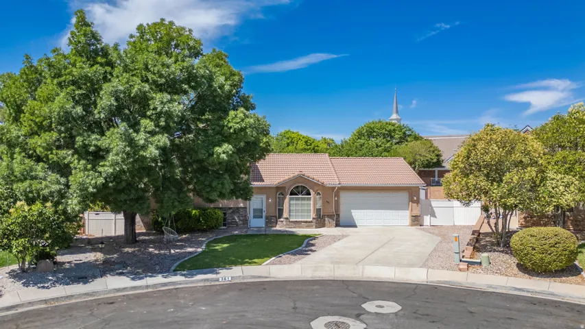 Single-story residence featuring a tile roof, an integrated two-car garage, and a concrete driveway