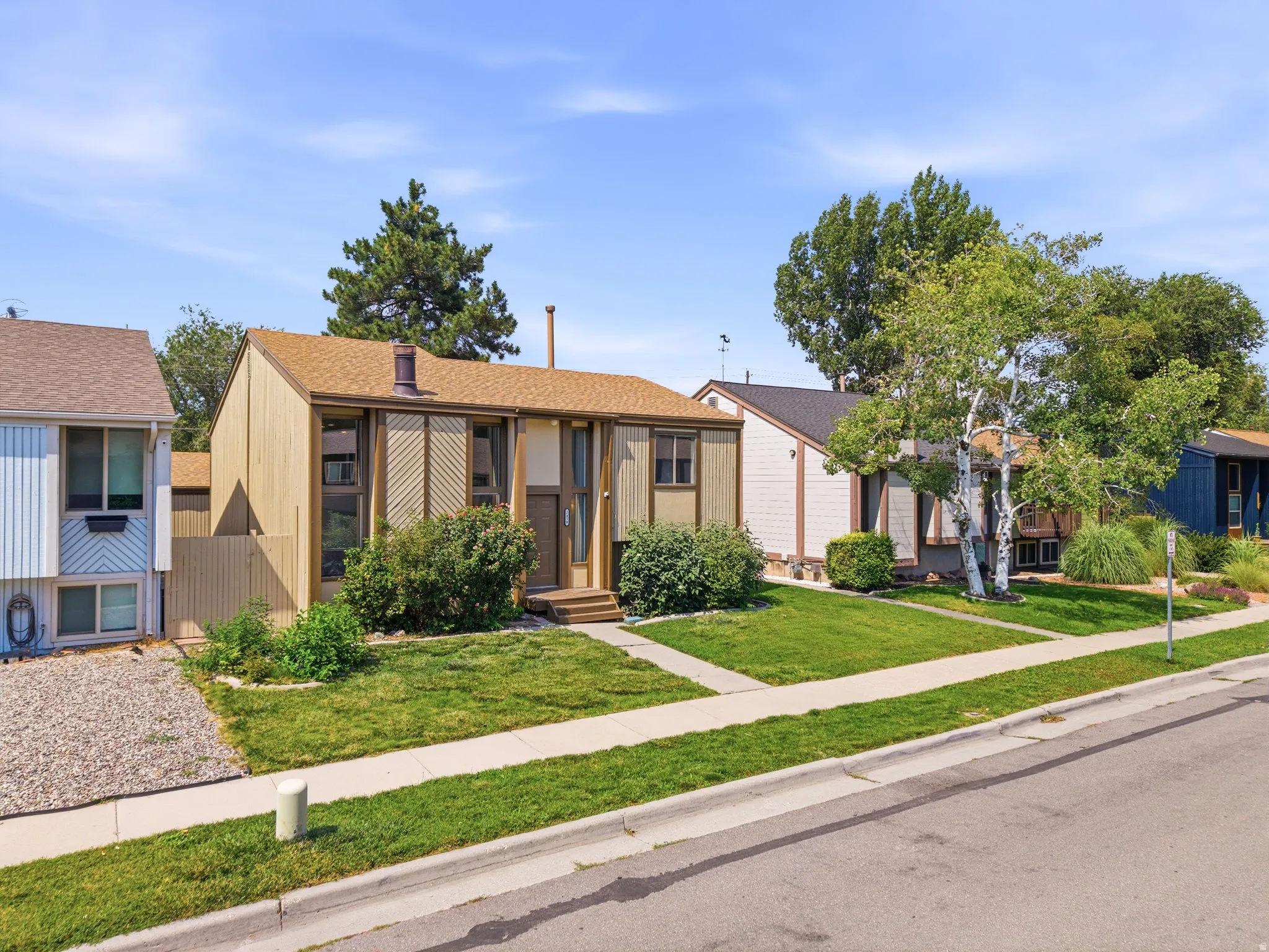 Mid-century modern residence featuring a brown shingle roof and vertical wood siding