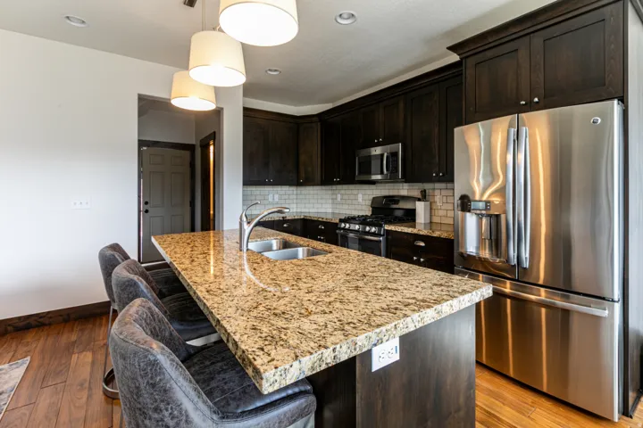 Kitchen island with granite countertop and double stainless steel sink