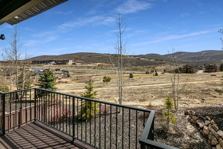 Balcony with black metal railings overlooking a mountain landscape