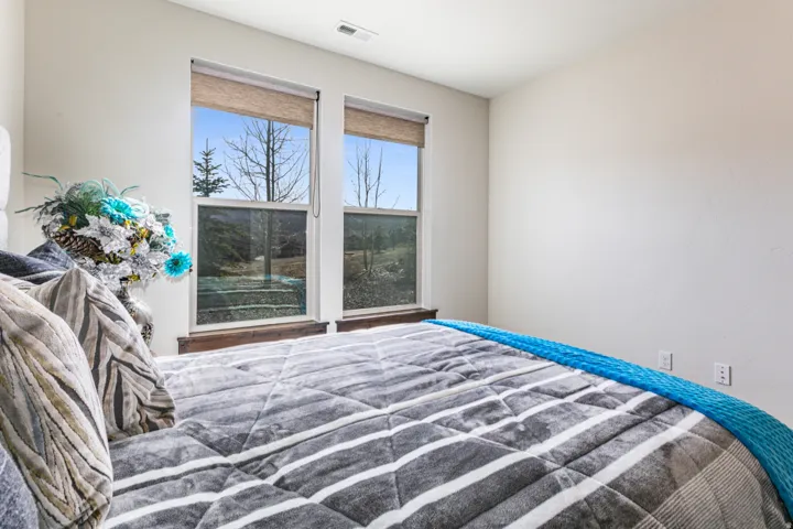 Bright interior space featuring two large windows with natural landscape views