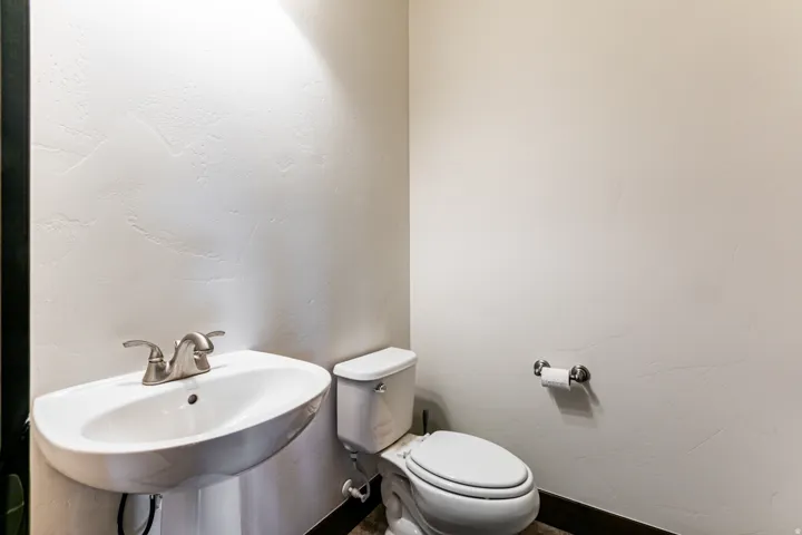 Pedestal sink with brushed nickel faucet