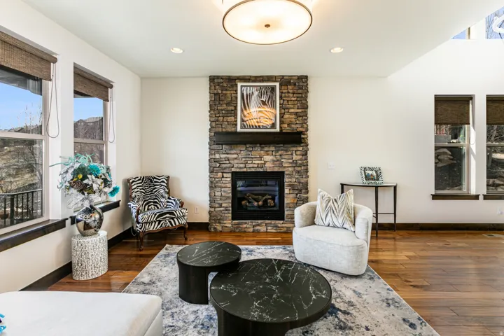 Stone-faced fireplace with a dark wood mantel and a gas insert