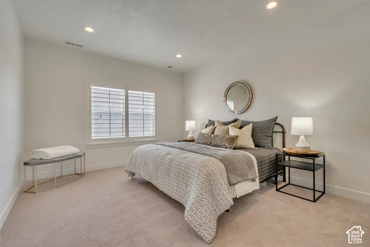 Carpeted bedroom featuring recessed lighting, a window with louvered shutters, and baseboard molding