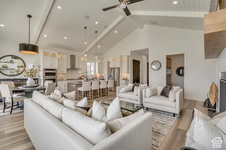 Open-concept living space featuring vaulted shiplap ceilings, wood-finish flooring, and recessed lighting