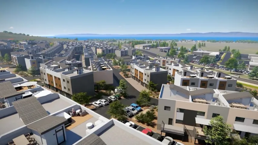 Contemporary residential development featuring multi-story units, flat and pitched rooflines, and a varied facade of light and dark finishes