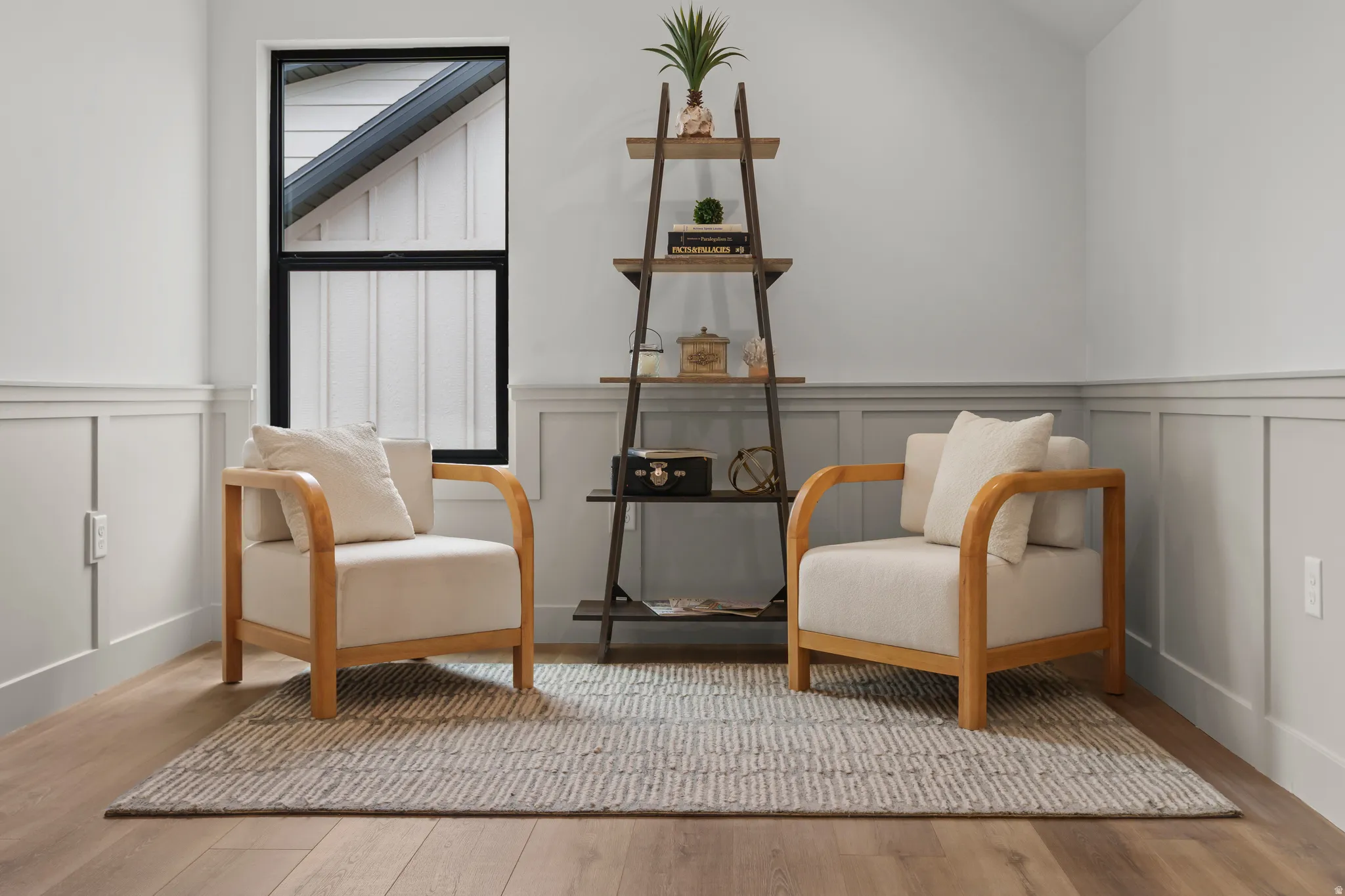 Board and batten wainscoting with a chair rail accentuates walls, complemented by wood-finish flooring