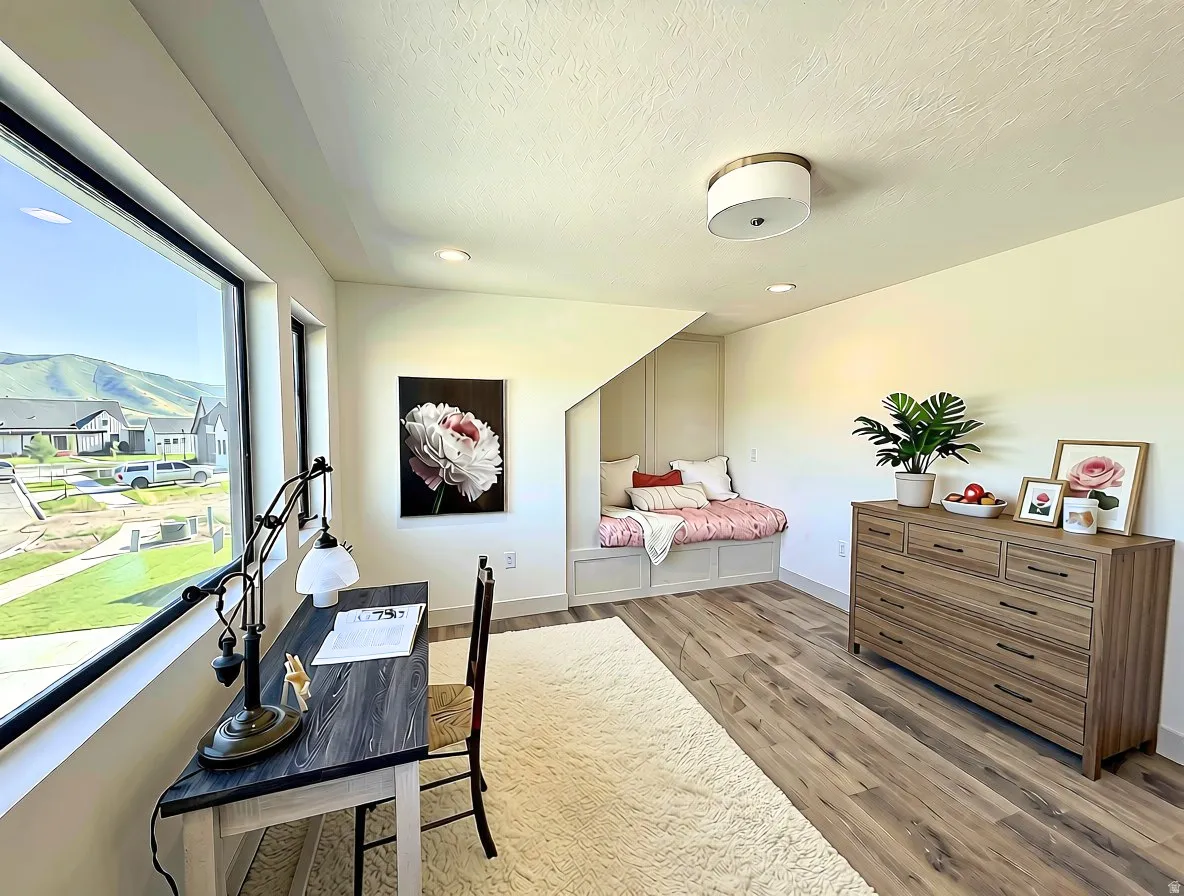 Dedicated room featuring wood-finish flooring, a built-in window seat, large windows, recessed lighting, and a flush mount ceiling fixture