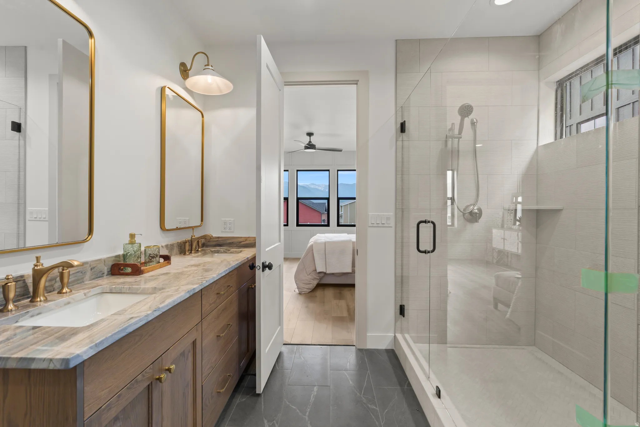Double vanity with gold-finish fixtures and framed mirrors