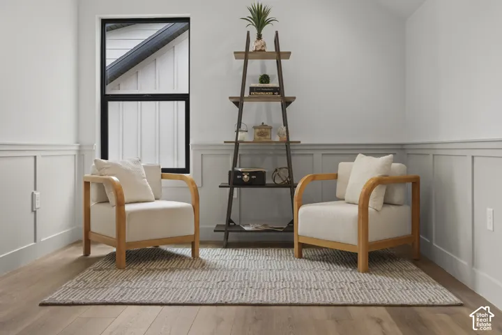 Board and batten wainscoting with a chair rail accentuates walls, complemented by wood-finish flooring