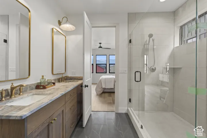 Double vanity with gold-finish fixtures and framed mirrors