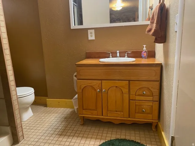 Wood-finish vanity with an integrated sink and chrome fixtures