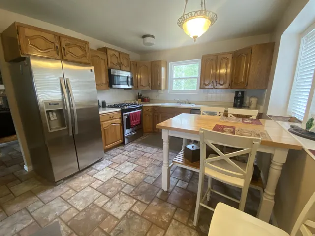 Kitchen featuring wood-finish cabinetry and stainless steel appliances.