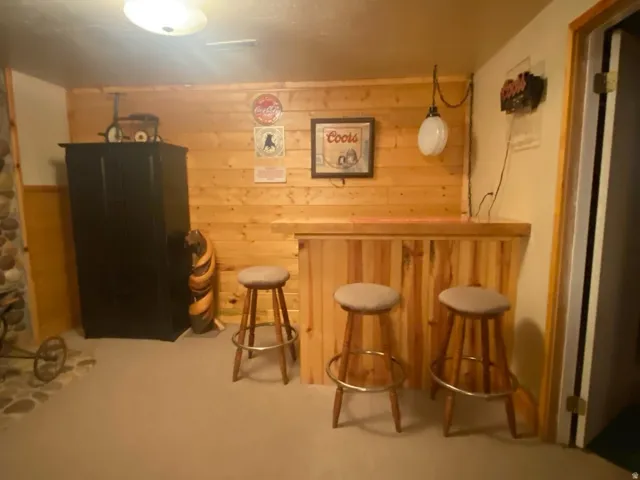 Custom-built wood bar featuring a wood countertop and paneling
