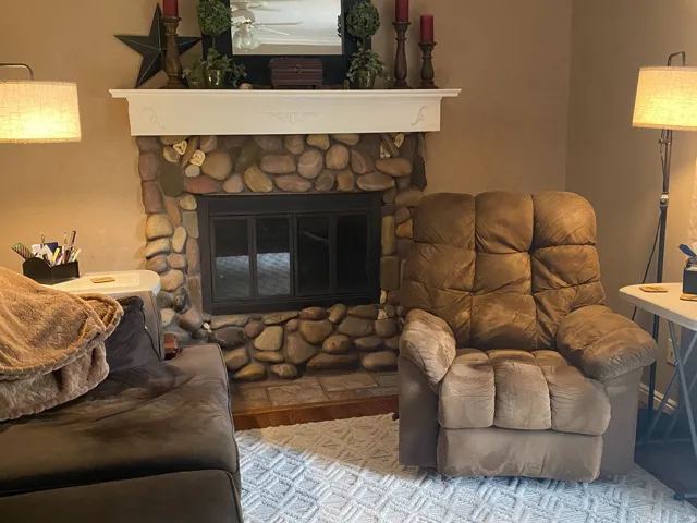 Stone-faced fireplace with a white mantel and crown molding