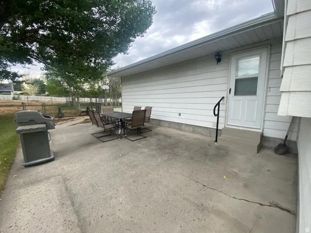 Concrete patio with white siding exterior