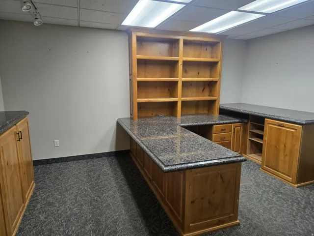 Large office with Built-in cabinetry with stone-finish countertops, integrated shelving, and track lighting